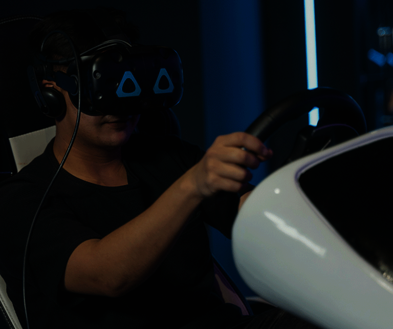 Person with VR headset in driving simulation