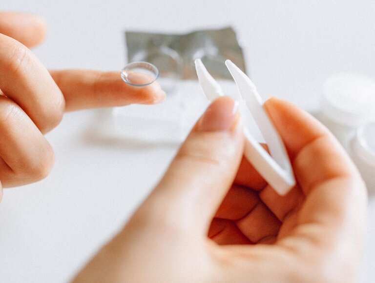 Person uses a contact lens