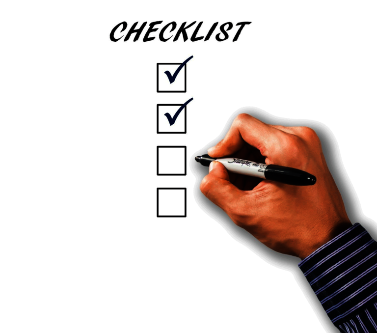 Hand with pen working through a checklist.