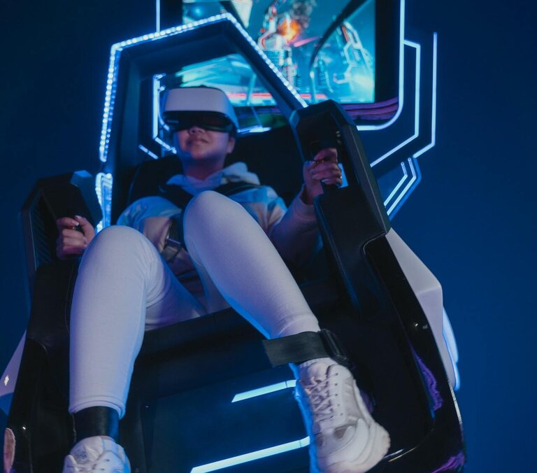 Person sits in VR simulator