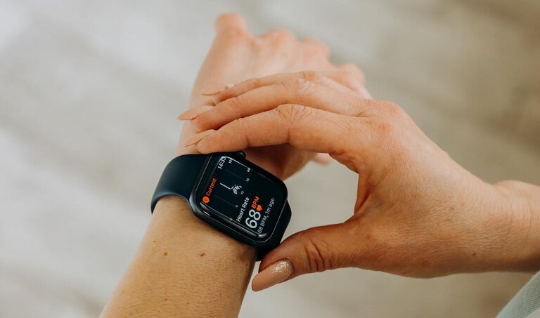 A picture of a human wrist wearing a smart watch.