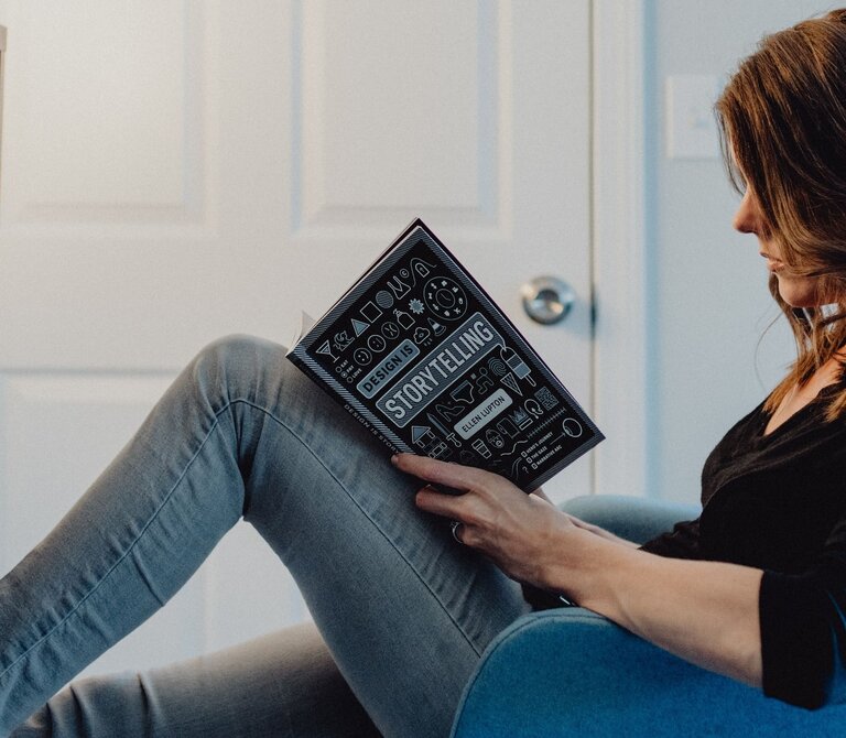 Woman reading a storytelling book.