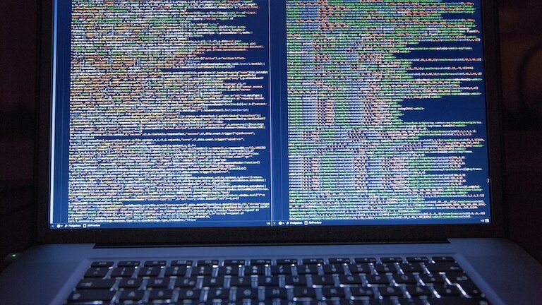 A laptop with a code editor open on its screen (Photo by Markus Spiske - pexels.com)