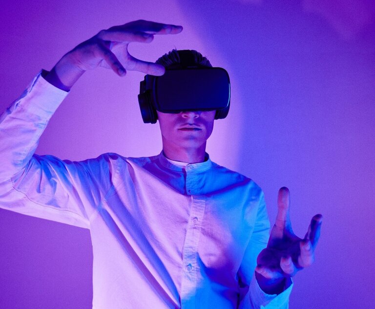 A person wearing a virtual reality headset and making gestures.